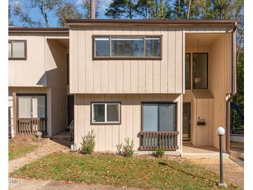 Two-story townhouse exterior features a modern design with multiple windows and a covered porch at 5073 Tall Pines Ct, Raleigh, NC 27609
