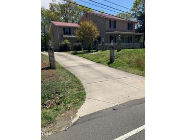 Charming two-story home with a long driveway and manicured lawn at 836 S Main St, Roxboro, NC 27573