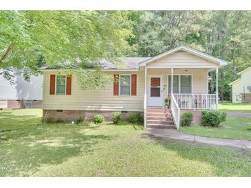 Charming single-story home featuring a cozy front porch and well-maintained landscaping at 109 Grange Dr, Wendell, NC 27591