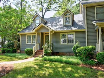 Charming home featuring dormer windows, well-maintained landscaping, and a brick walkway at 119 Long Shadow Ln, Cary, NC 27518