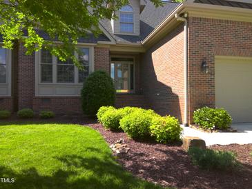 Well maintained brick home with mature landscaping and a manicured lawn at 12 Crail Ct, Durham, NC 27712