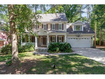 Charming two-story home with a covered front porch, landscaped yard, and a two-car garage at 124 Cypress View Way, Apex, NC 27502