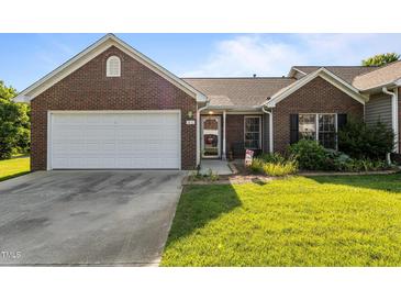 Charming brick home with a two-car garage, landscaped lawn, and inviting front porch at 3027 Maple Ave # U1, Burlington, NC 27215