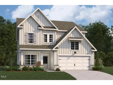 Charming two-story home with board and batten siding, attached two-car garage, and a well-manicured lawn at 4301 Emeline Way # 15, Fuquay Varina, NC 27526