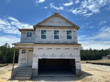 New two-story home with visible framework and covered front porch, ready to customize at 433 Old Fashioned Way, Lillington, NC 27546