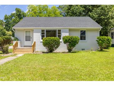 Charming single-story home with a well-maintained lawn and manicured bushes at 605 E Montgomery St, Henderson, NC 27536