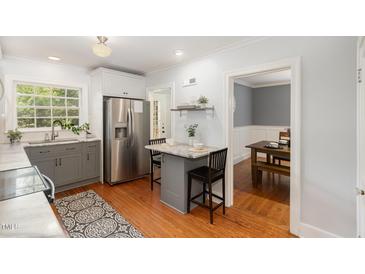 Bright kitchen with stainless steel appliances, a marble countertop, and eat-in breakfast bar at 821 Onslow St, Durham, NC 27705