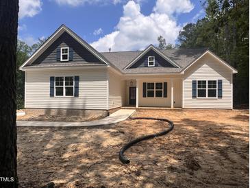 Charming single-story home with navy blue shutters and gables, complemented by a landscaped yard at 987 Lewis Rd, Zebulon, NC 27597