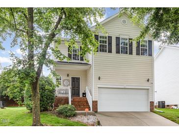 Charming two-story home with a well-maintained lawn and an attached two-car garage at 109 Troyer Pl, Apex, NC 27502