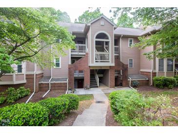 Charming condo exterior with brick accents and well-maintained landscaping at 115 Abingdon Ct # 2B, Cary, NC 27513