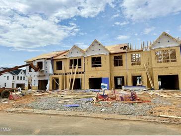New construction townhomes displaying framing, and plywood sheathing with visible underlayment along the roofs at 153 Ripple Way # 208, Clayton, NC 27520