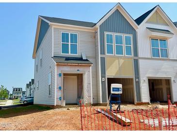 New construction of two-story townhome with attached garage and gray and white siding at 75 Ripple Way # 216, Clayton, NC 27520