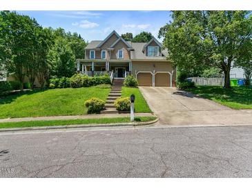 Inviting two-story home with a well-manicured lawn and a two-car attached garage at 10205 Sorrills Creek Ln, Raleigh, NC 27614