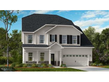 Charming two-story home with a well-manicured lawn and traditional architectural details at 1021 Dillon Lake Dr, Knightdale, NC 27545