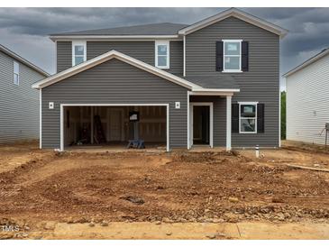 New two-story home with gray siding, open garage and unfinished landscaping at 2250 Cherry Creek Rd, Haw River, NC 27258