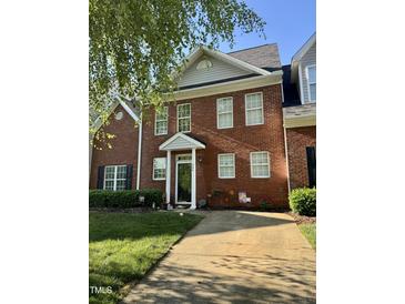 Charming brick townhome featuring a well-manicured front lawn and inviting front entrance at 364 Bayleigh Ct, Garner, NC 27529
