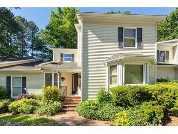 Charming two-story home with a landscaped front yard and inviting entryway at 411 Brampton Close, Pittsboro, NC 27312