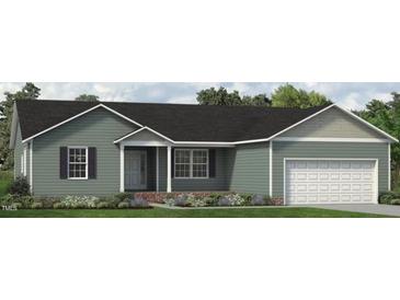 Charming single-story home with a well-maintained lawn, attached garage, and inviting front porch at 4451 Poppy Mallow Ln, Oxford, NC 27565