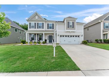 Charming two-story home with a well-manicured lawn, inviting front porch, and a two-car attached garage at 4907 Sleepy Falls Run, Knightdale, NC 27545