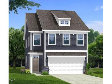 Charming two-story home featuring a two-car garage, dormer, and landscaped yard at 5208 Ranger Grove Way, Raleigh, NC 27604