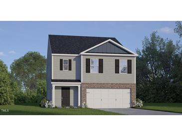Charming two-story home with gray siding, brick accents, and a well-manicured lawn at 556 Stream Walk Xing, Wendell, NC 27591