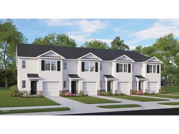 Charming townhome exterior with black shutters, white siding, and a single-car garage at 563 Stream Walk Xing, Wendell, NC 27591
