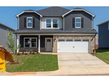 Charming two-story home with a well-manicured lawn and a two car garage at 716 Deschutes Dr, Garner, NC 27529