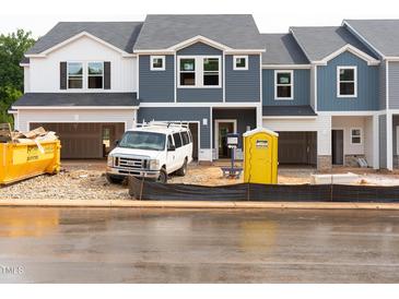 New construction townhomes featuring Hardie board siding, and attached garages at 1029 Winding Spring Dr, Mebane, NC 27302