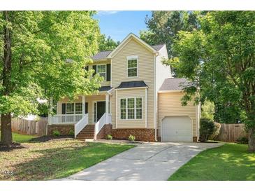 Charming two-story home with manicured lawn, attached garage and welcoming front porch at 121 River Hills Dr, Clayton, NC 27527