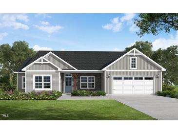 Charming one-story home with stone accents, gray siding, well-manicured lawn and an attached two-car garage at 260 Pretty Run Branch Ln, Wendell, NC 27591