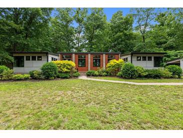 Charming single-story home with lush landscaping and a well-manicured lawn at 3095 Champs Way, Mebane, NC 27302
