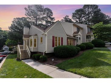 Charming townhome featuring red shutters and lush landscaping in a well-maintained community at 6516 Hearthstone Dr # 6516, Raleigh, NC 27615