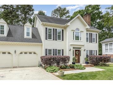 Charming two-story home with a well-manicured lawn and attached two-car garage at 104 Odessa Cir, Cary, NC 27513