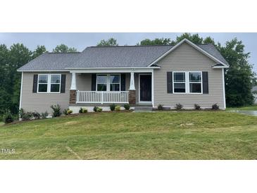 Charming single-story home with a covered front porch and well-maintained lawn at 170 Starry Sky Dr, Benson, NC 27504