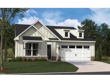 Charming two-story home featuring a white exterior, a two-car garage, and a professionally landscaped front yard at 2016 Kapalua Way # 195, Durham, NC 27703