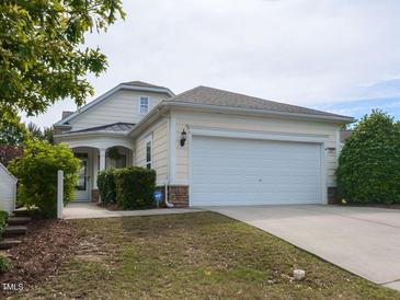 Charming home featuring a two-car garage, landscaped yard, and inviting entrance at 207 Callum Pl, Cary, NC 27519