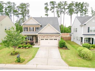 Charming two-story home featuring a well-manicured front yard, a two-car garage, and lovely landscaping at 2511 Kestrel Heights Ct Ct, Durham, NC 27703