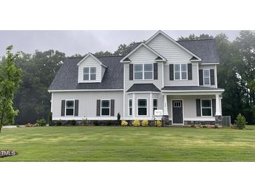 Two-story home featuring gray siding, a dark roof, and a well-manicured lawn at 268 Busterfield Ct, Benson, NC 27504
