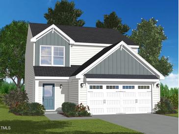 Charming two-story home with white siding and a two-car garage, beautifully landscaped at 2700 Barrington Dr, Raleigh, NC 27610