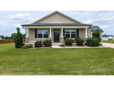 Charming one-story home with a well-manicured lawn and inviting front porch at 286 Beaver Tavern Dr, Benson, NC 27504