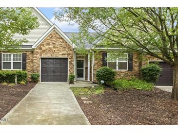 Attractive house with stone facade, well-kept landscaping, and a two-car garage at 309 Plank Bridge Way, Morrisville, NC 27560