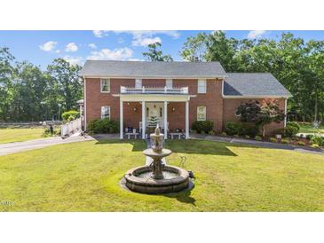 Stately brick home boasts a charming front yard and fountain focal point at 4024 Rural Retreat Rd, Burlington, NC 27215