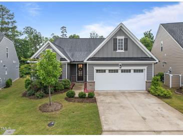 Charming single-story home with a well-manicured lawn, two car garage, and neutral gray siding at 1010 Sandbar Ln, Durham, NC 27703