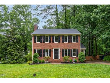 Charming brick two-story home with black shutters and a well-manicured lawn at 11816 Stannary Pl, Raleigh, NC 27613