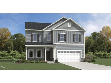 Charming two-story home featuring stone accents, a two-car garage, and a well-manicured lawn at 1205 Cosmic Dr, Durham, NC 27703