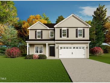 Charming two-story home with a well-manicured lawn and a two-car garage at 138 Jones Creek Ln, Lillington, NC 27546