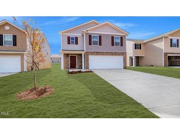 Charming two-story home with a well-manicured lawn and a two car garage at 2132 Monk Dr, Haw River, NC 27258
