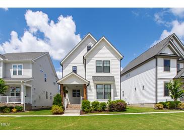 Beautiful two-story home featuring white siding, black-framed windows, and a well-manicured lawn on a sunny day at 248 Daniel Ridge Rd, Wendell, NC 27591