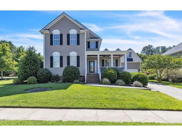 Charming two-story home with a welcoming front porch and well-manicured lawn at 30155 Pharr, Chapel Hill, NC 27517