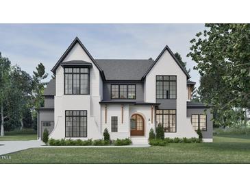Striking two-story home showcasing a modern aesthetic with its brick facade and sleek black-trimmed windows at 5013 Coronado, Raleigh, NC 27609